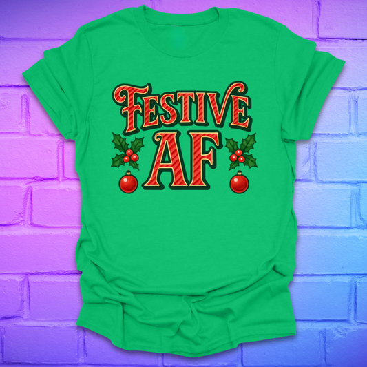 Green t-shirt with 'Festive AF' text and holly design on a purple brick wall background
