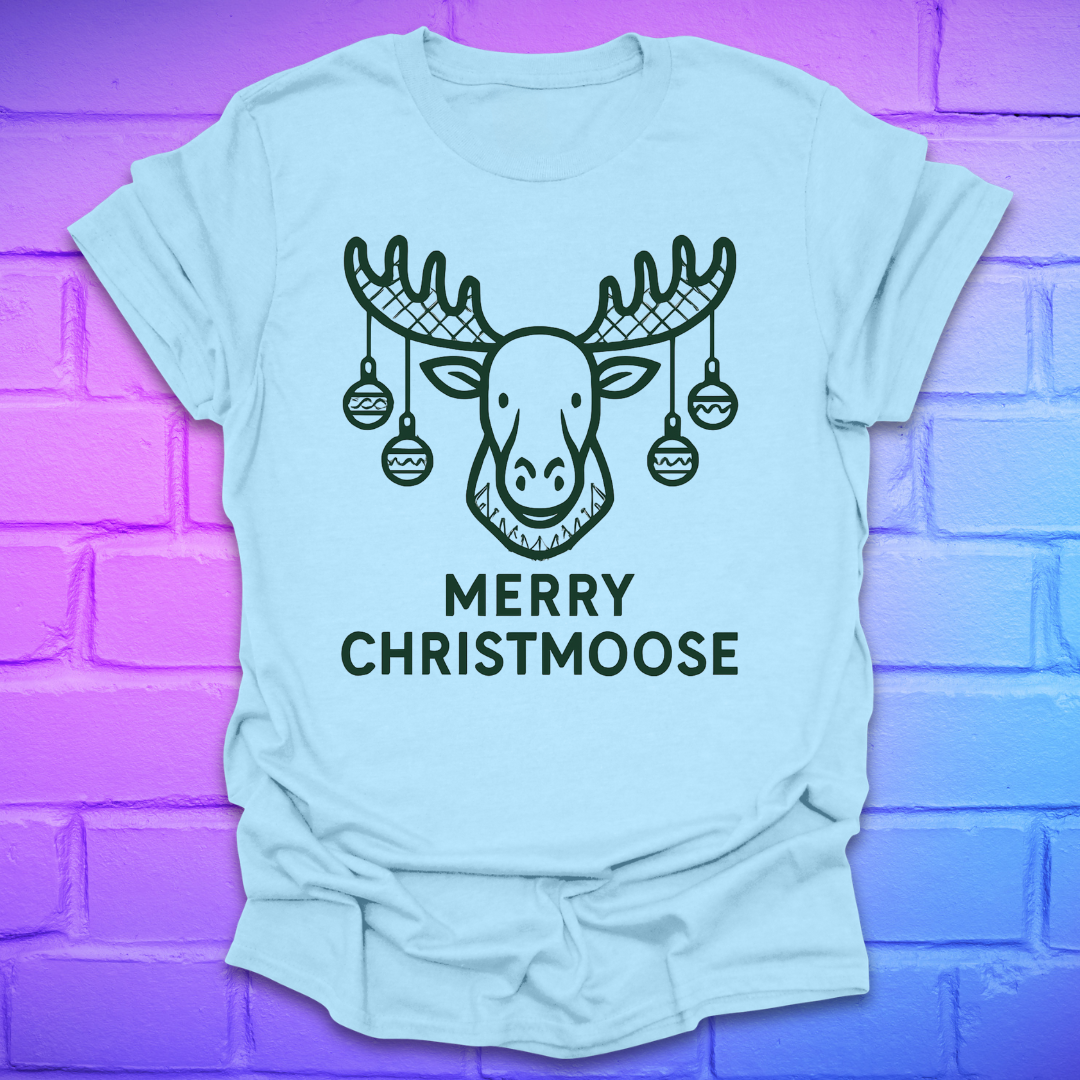 Light blue t-shirt with a moose graphic and 'Merry Christmoose' text on a brick wall background
