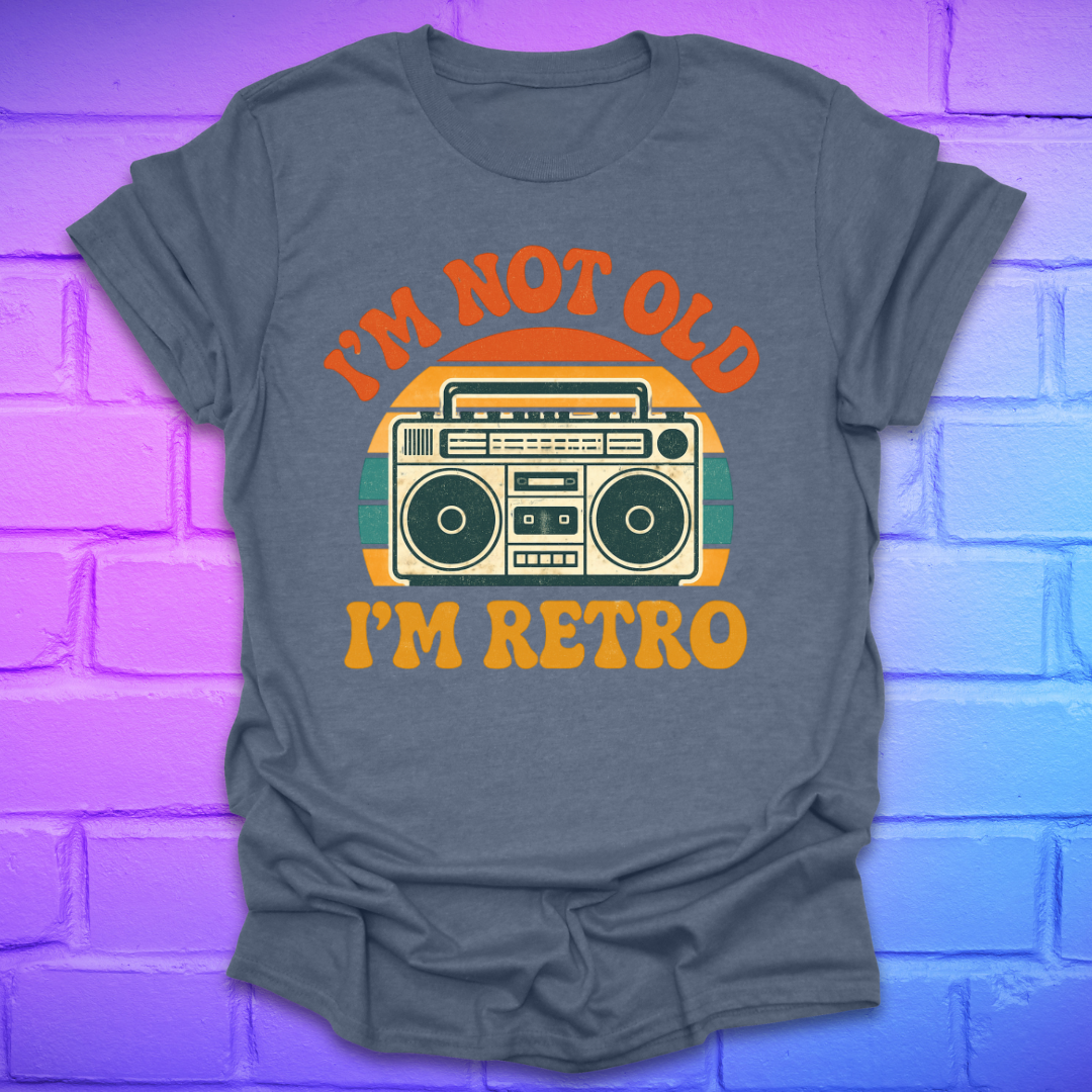 Gray t-shirt with 'I'm Not Old, I'm Retro' graphic design on a brick wall background