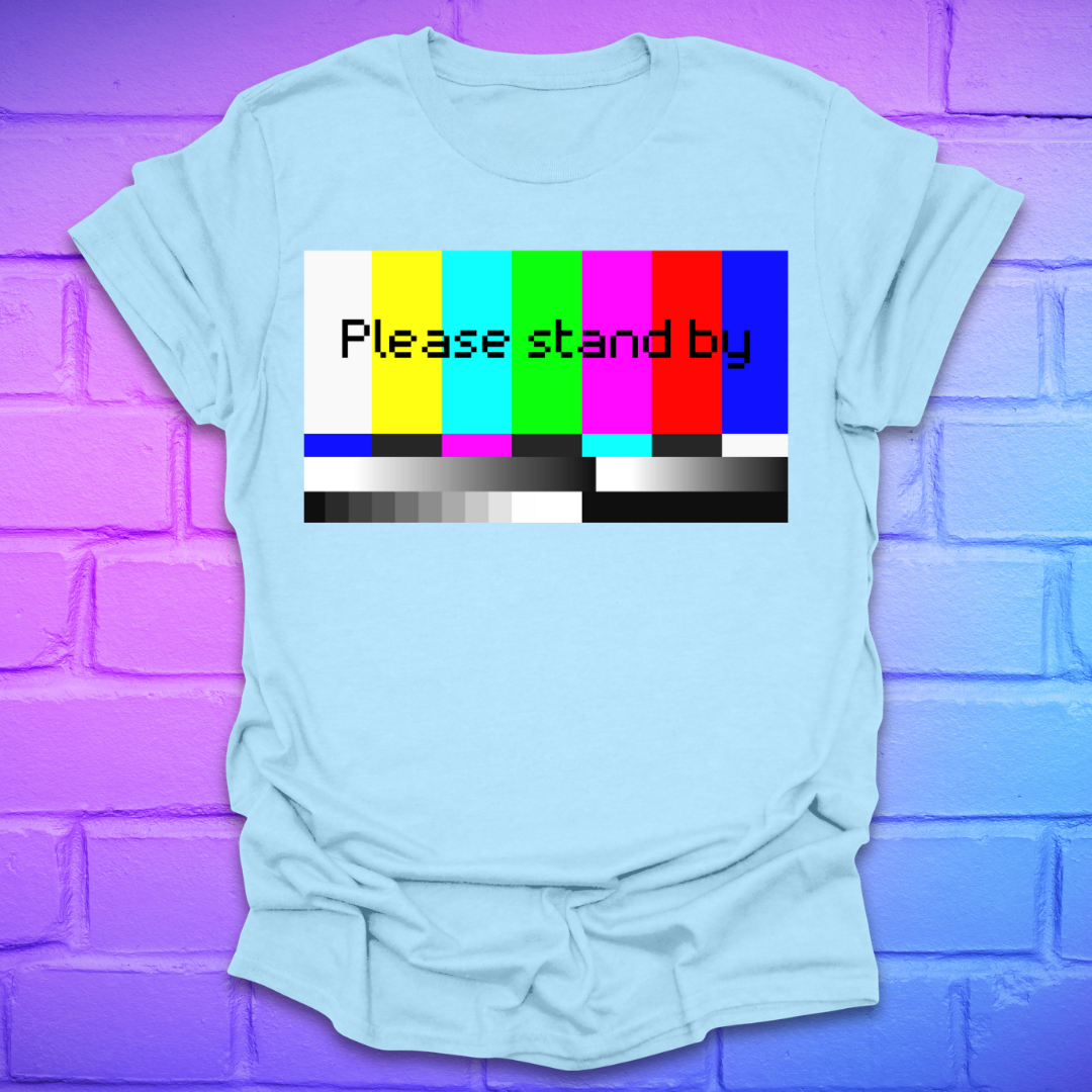 Light blue t-shirt with a 'Please stand by' graphic on a purple brick wall background