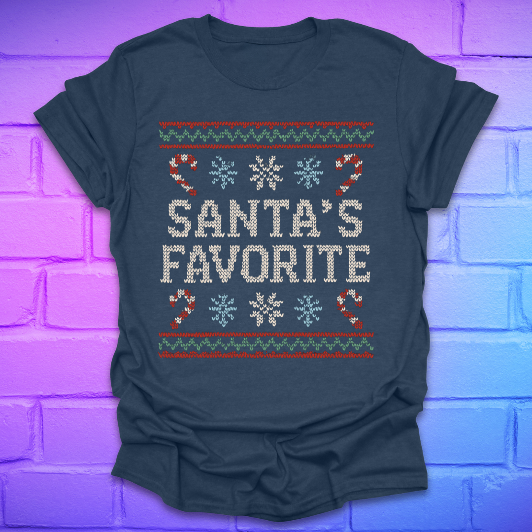 Light navy t-shirt with Christmas-themed design, and text, 'Santa's Favorite' on a brick wall background