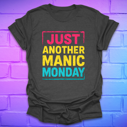Grey t-shirt with bright bold text, 'Just another manic monday' on a brick background.