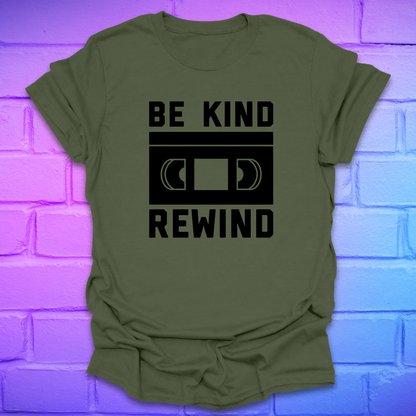Green t-shirt with 'Be Kind Rewind' text on a brick wall background