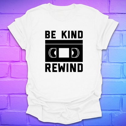 White t-shirt with 'Be Kind Rewind' design on a colorful brick wall background
