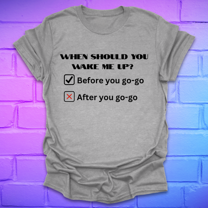 Gray t-shirt with humorous text design on a brick wall background