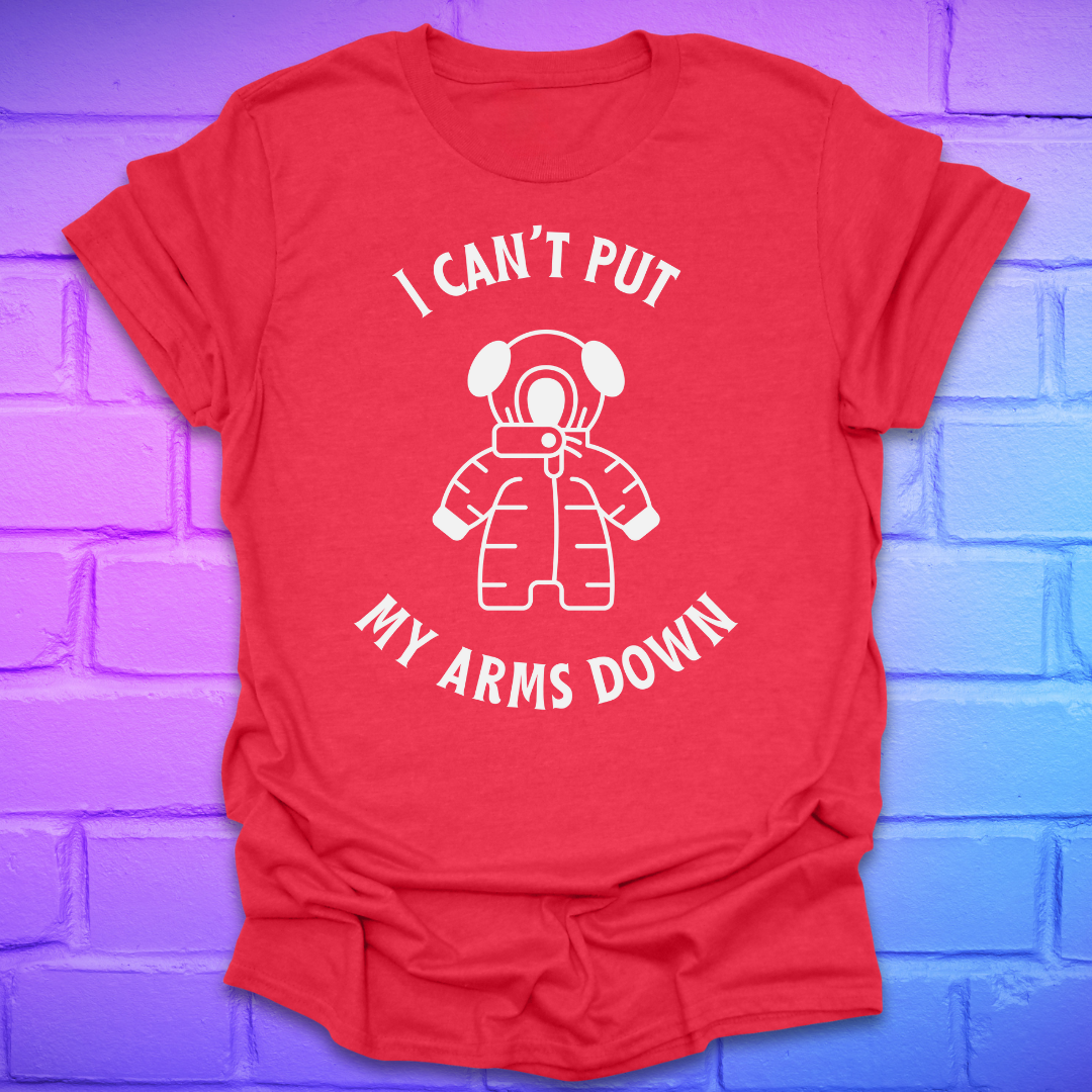 Red t-shirt with white graphic and text, 'i can't put my arms down' on a brick wall background
