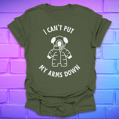 Green t-shirt with white graphic and text, 'i can't put my arms down' on a brick wall background