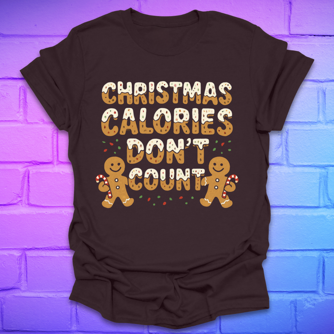Brown tshirt with festive gingerbread text, 'Christmas calories don't count' with gingerbread men on a brick background.
