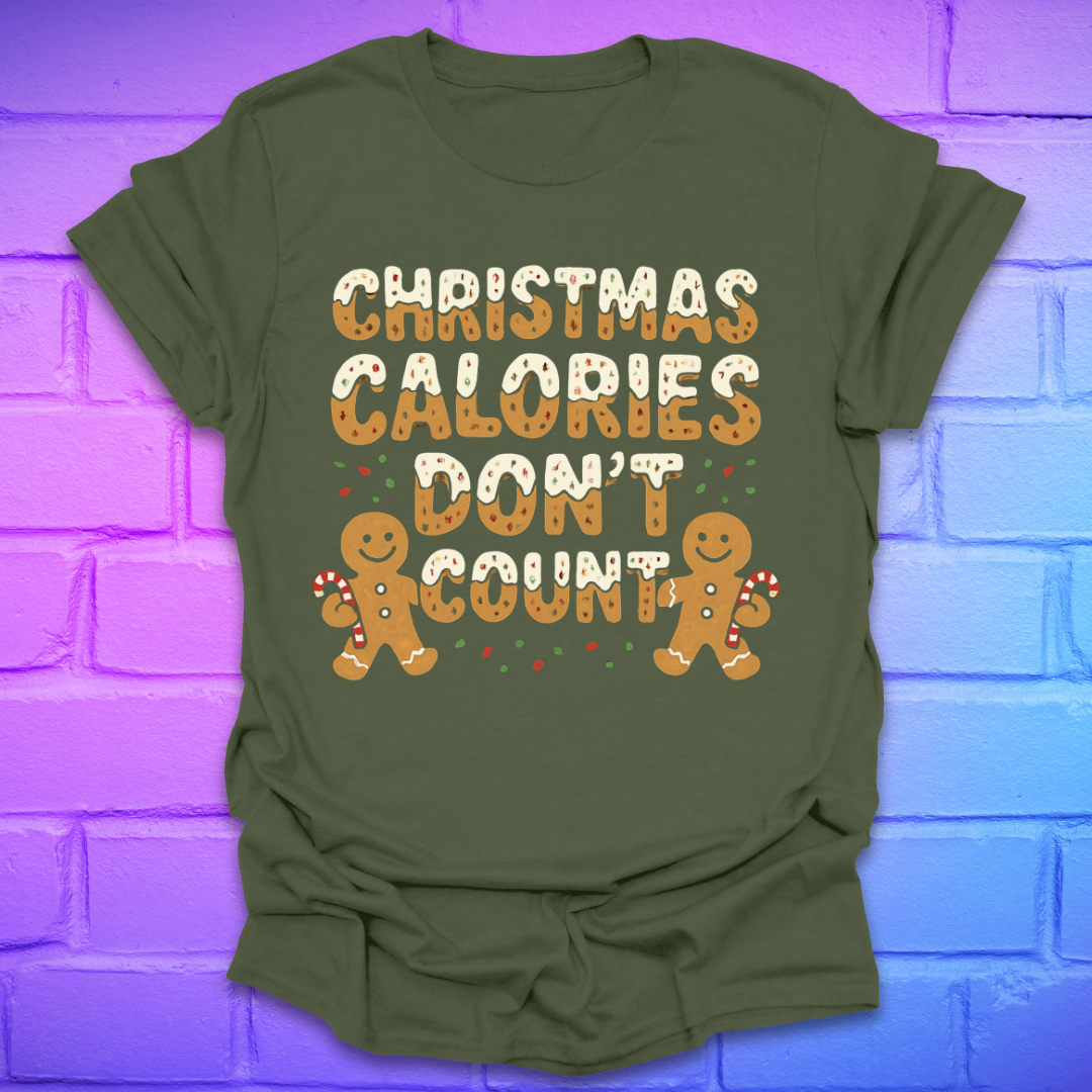 Green tshirt with festive gingerbread text, 'Christmas calories don't count' with gingerbread men on a brick background.