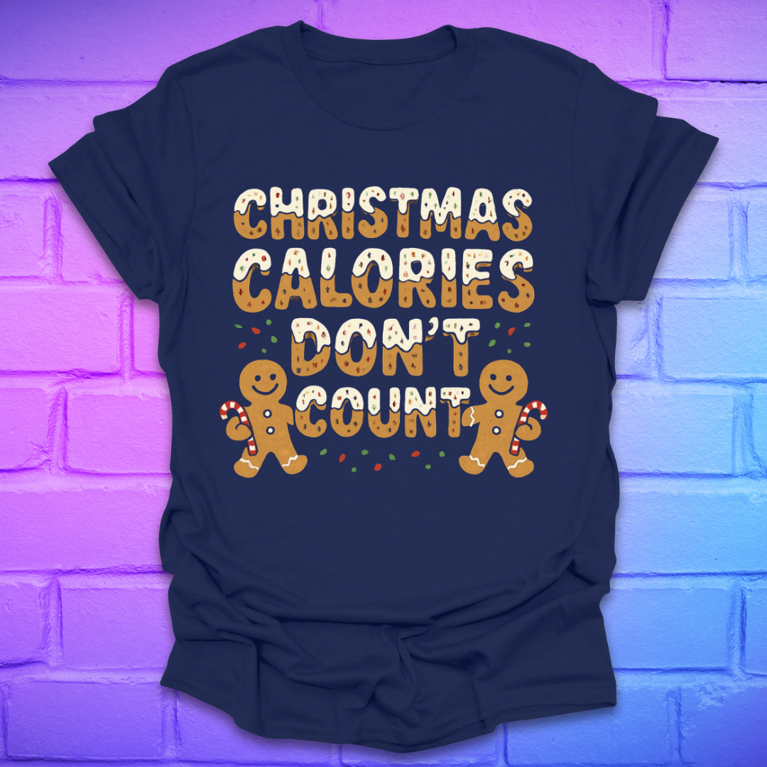 Navy tshirt with festive gingerbread text, 'Christmas calories don't count' with gingerbread men on a brick background.