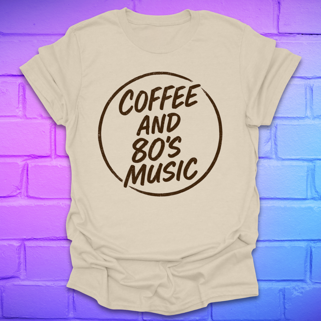 Beige t-shirt with 'Coffee and 80's Music' text on a brick wall background