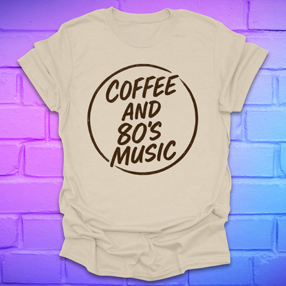 Beige t-shirt with 'Coffee and 80's Music' text on a brick wall background