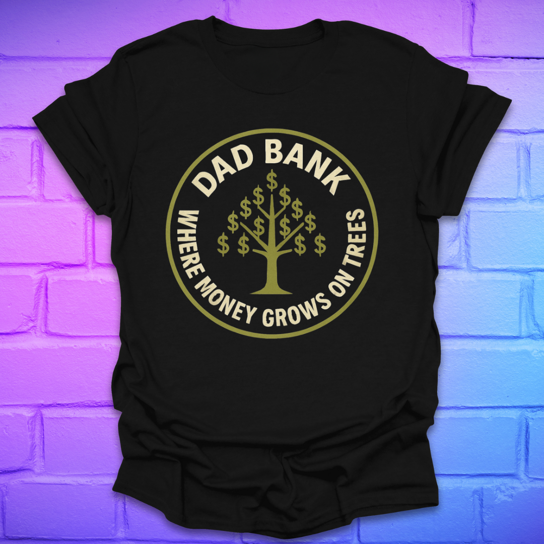 Black t-shirt with gold graphic and text 'Dad Bank. where money grows on trees' on a brick wall background