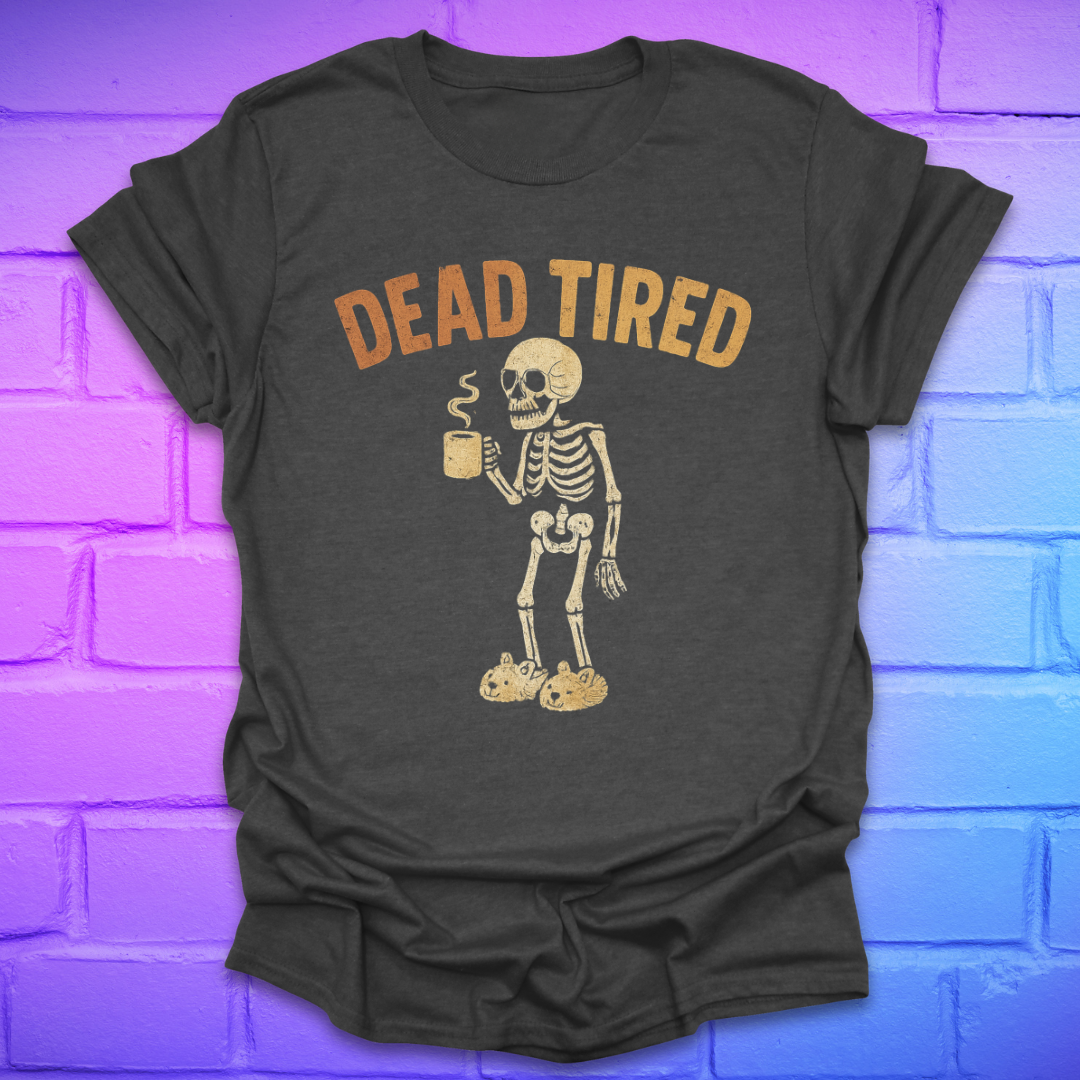 Dark gray t-shirt with skeleton holding a coffee cup and 'DEAD TIRED' text on a brick wall background
