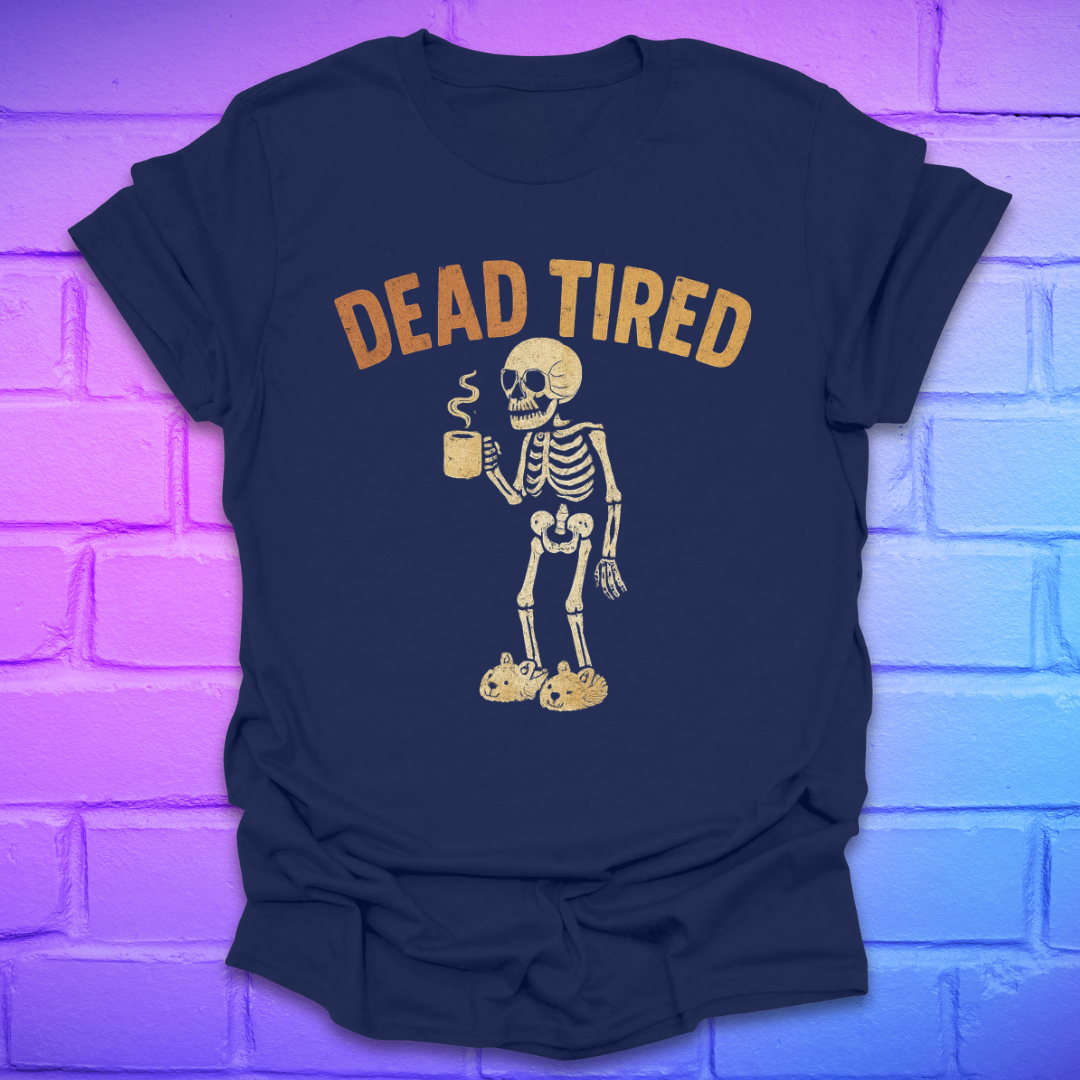 Navy blue t-shirt with a skeleton holding a coffee cup and 'DEAD TIRED' text on a brick wall background.