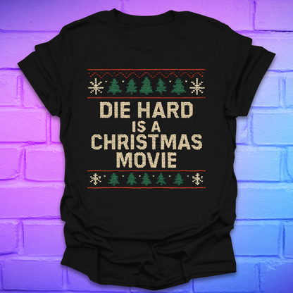 Black t-shirt with 'Die Hard is a Christmas Movie' text and festive design on a brick wall background