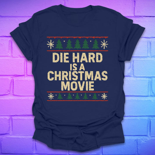 Navy blue t-shirt with sweater print 'Die Hard is a Christmas Movie' text on a brick wall background