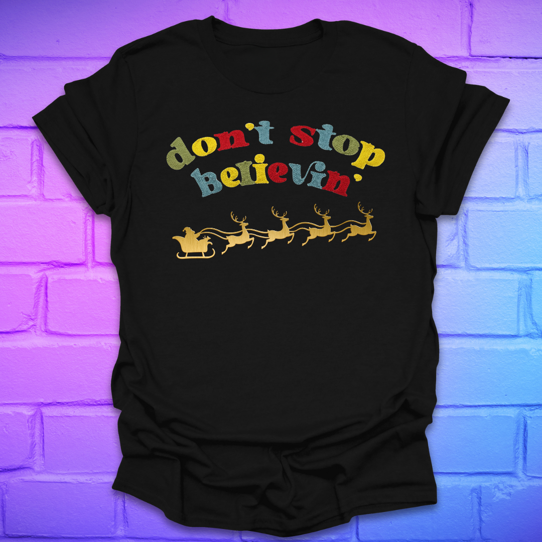 Black tshirt with text, 'don't stop believin' with a santa and sleigh on a brick background