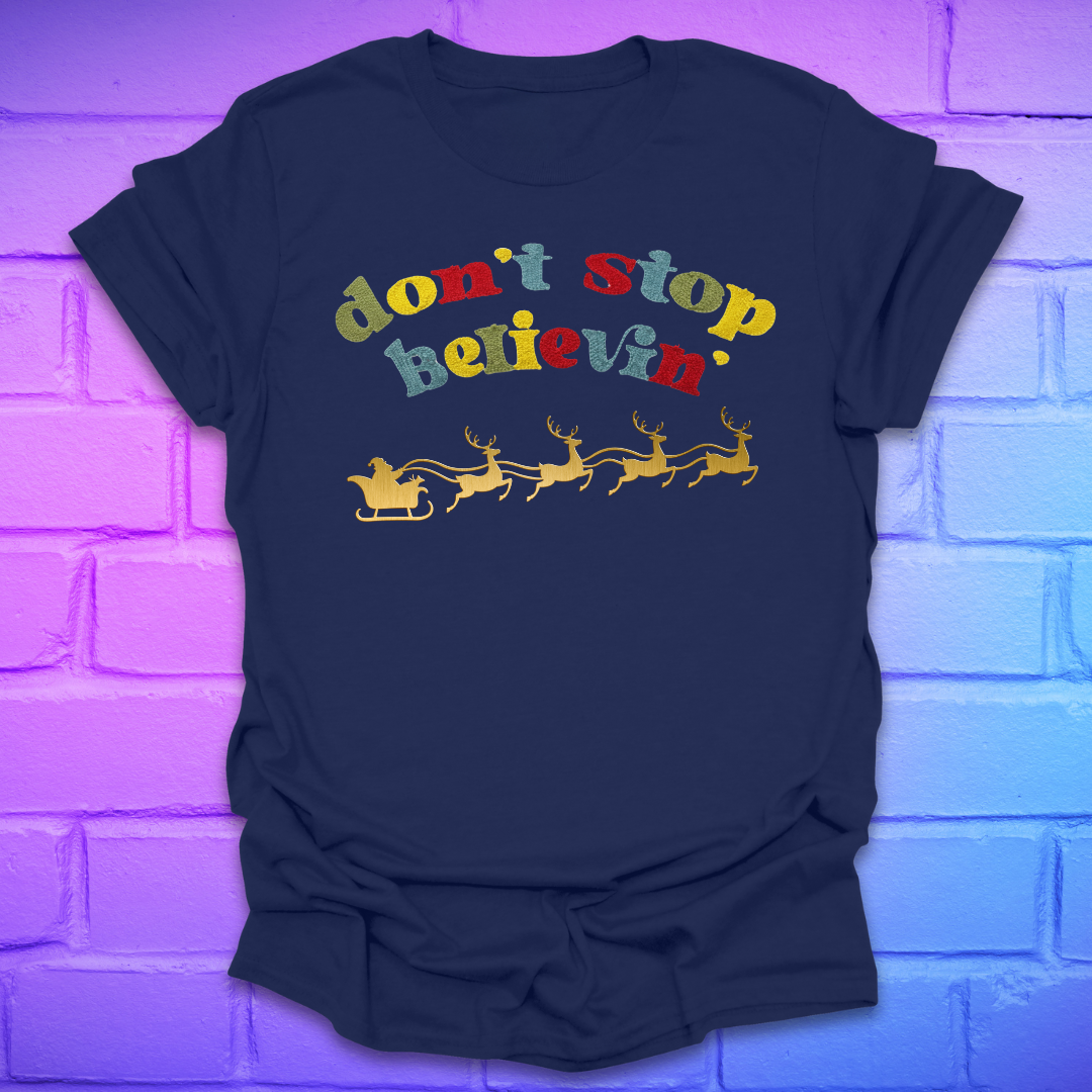 navy blue tshirt with text, 'don't stop believin' with a santa and sleigh on a brick background
