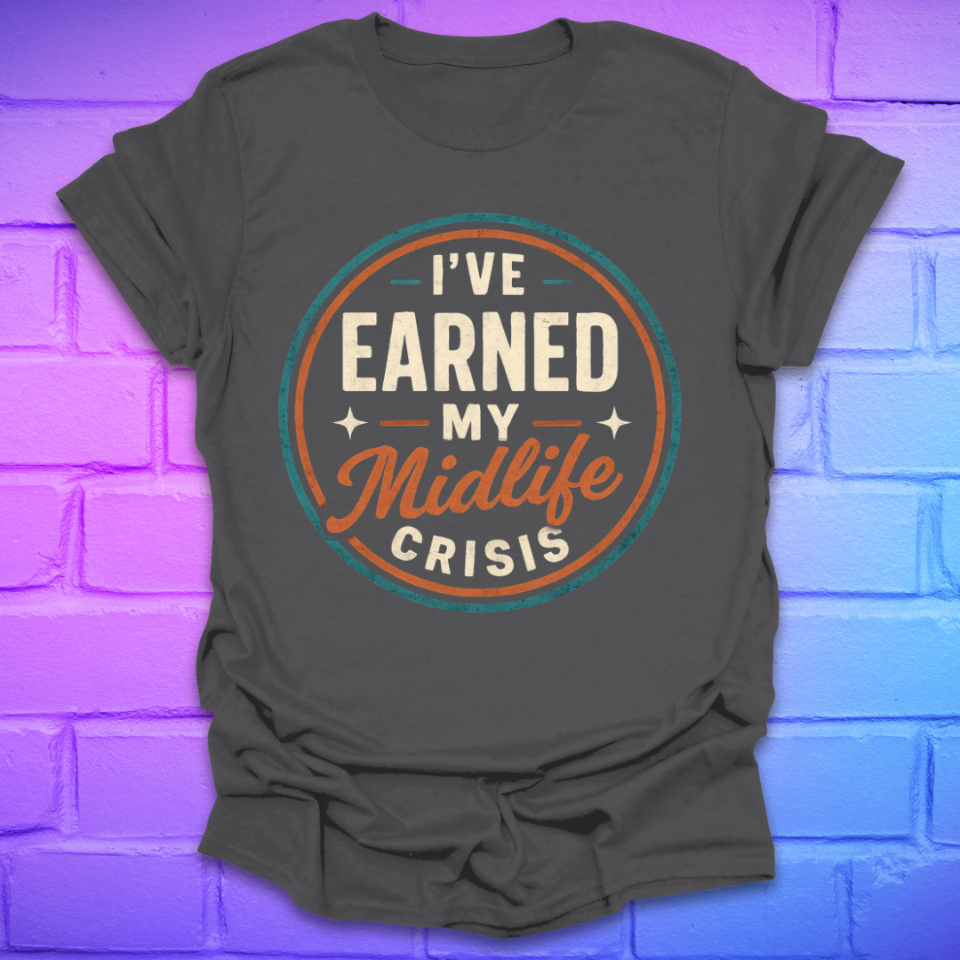Gray t-shirt with 'I've Earned My Midlife Crisis' text on a purple brick wall background