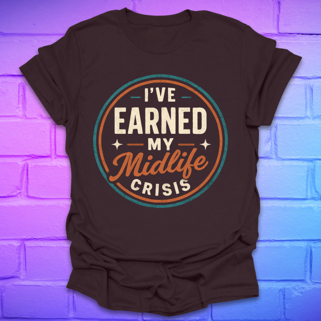 Brown t-shirt with 'I've Earned My Midlife Crisis' text on a brick wall background