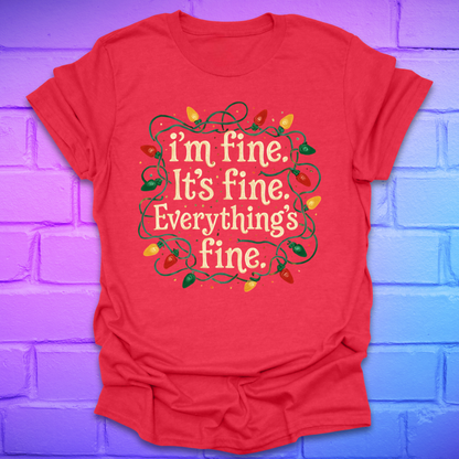 Red t-shirt with tangled christmas lights and text 'I'm fine. it's fine. everything's fine.' on a brick background.