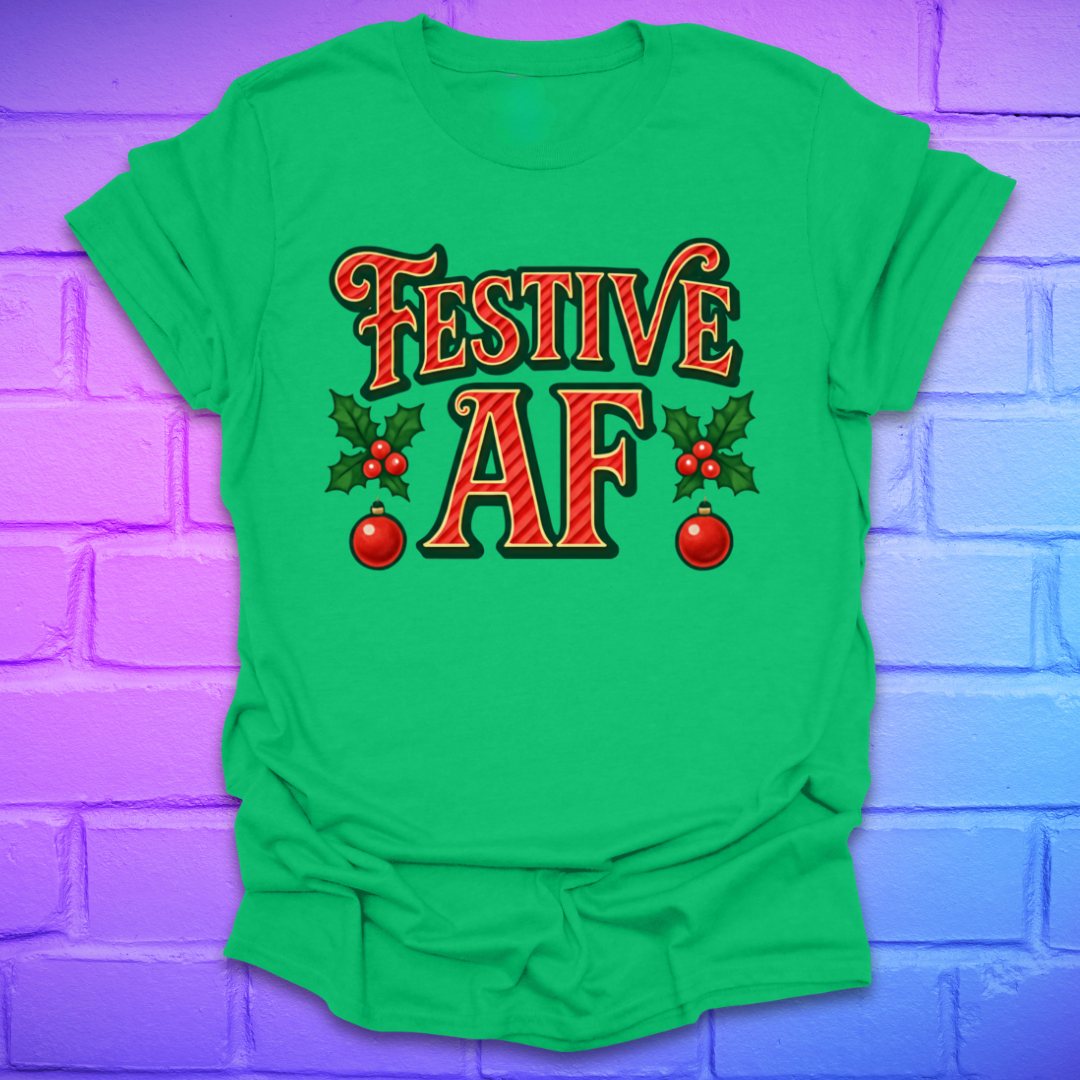 Green t-shirt with 'Festive AF' text and holly design on a purple brick wall background