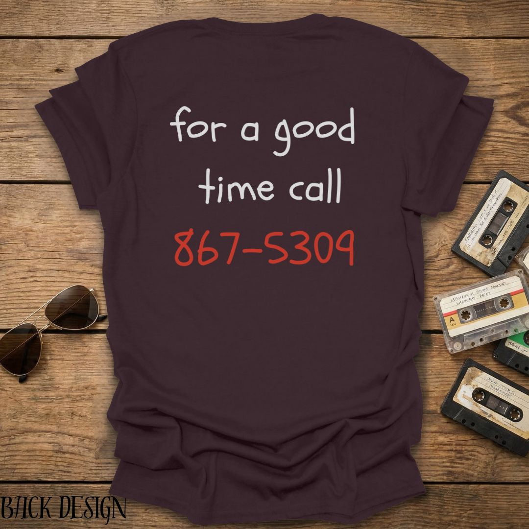Brown t-shirt with phone number design on a wooden surface with vintage cassettes and sunglasses.
