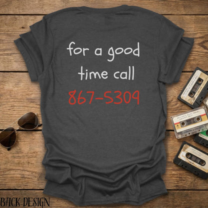 Gray t-shirt with phone number on a wooden surface with sunglasses and cassettes.