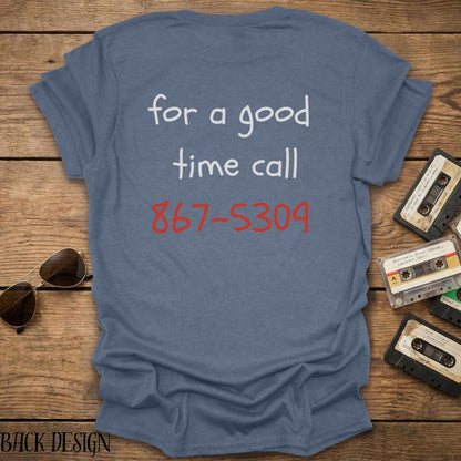 Light blue t-shirt with phone number design on a wooden surface with vintage cassettes and sunglasses.
