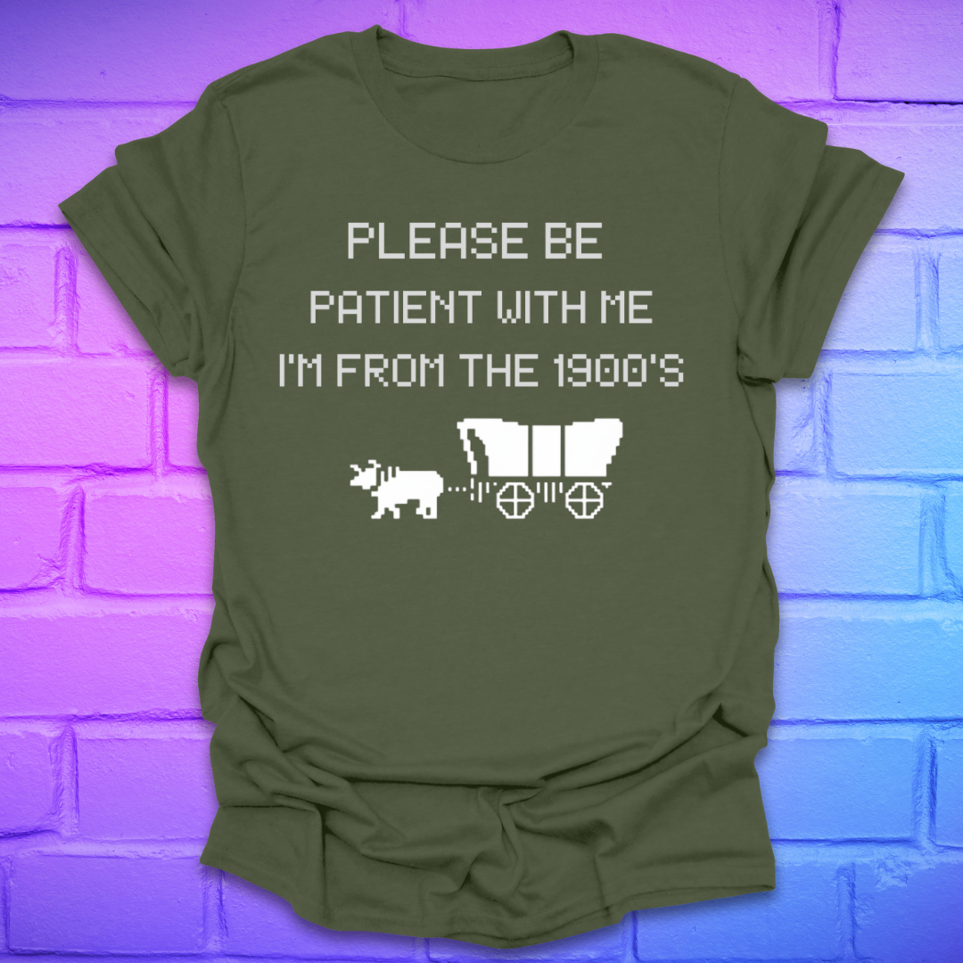 Green t-shirt with white text, 'please be patient with me im from the 1900s' and graphics on a brick wall background
