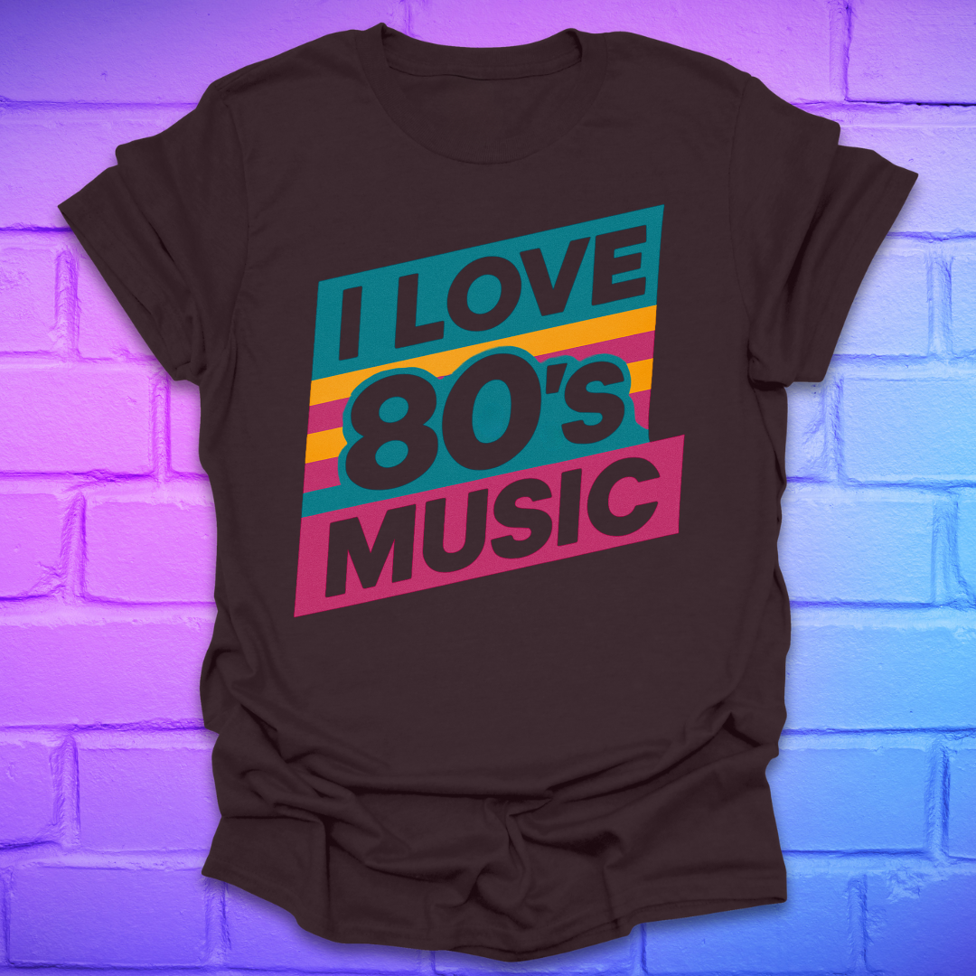 Brown t-shirt with 'I Love 80's Music' text on a brick wall background