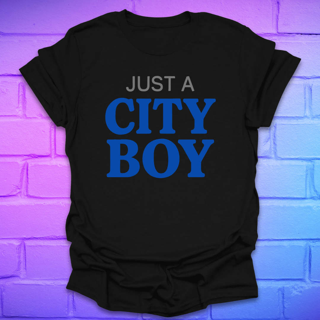Black t-shirt with 'Just a City Boy' text in blue on a brick wall background