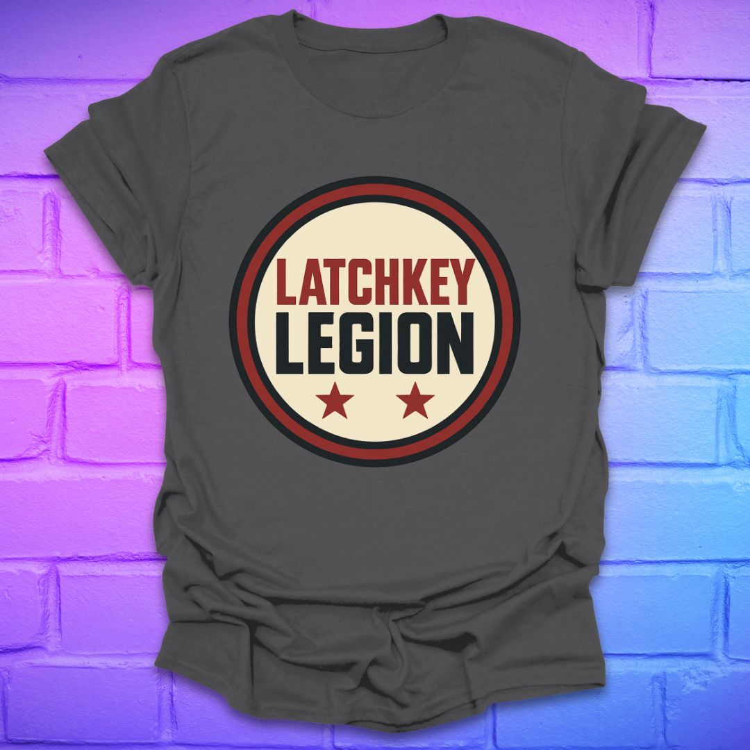 Gray t-shirt with text, 'Latchkey Legion'  in a circle with stars design on a brick wall background