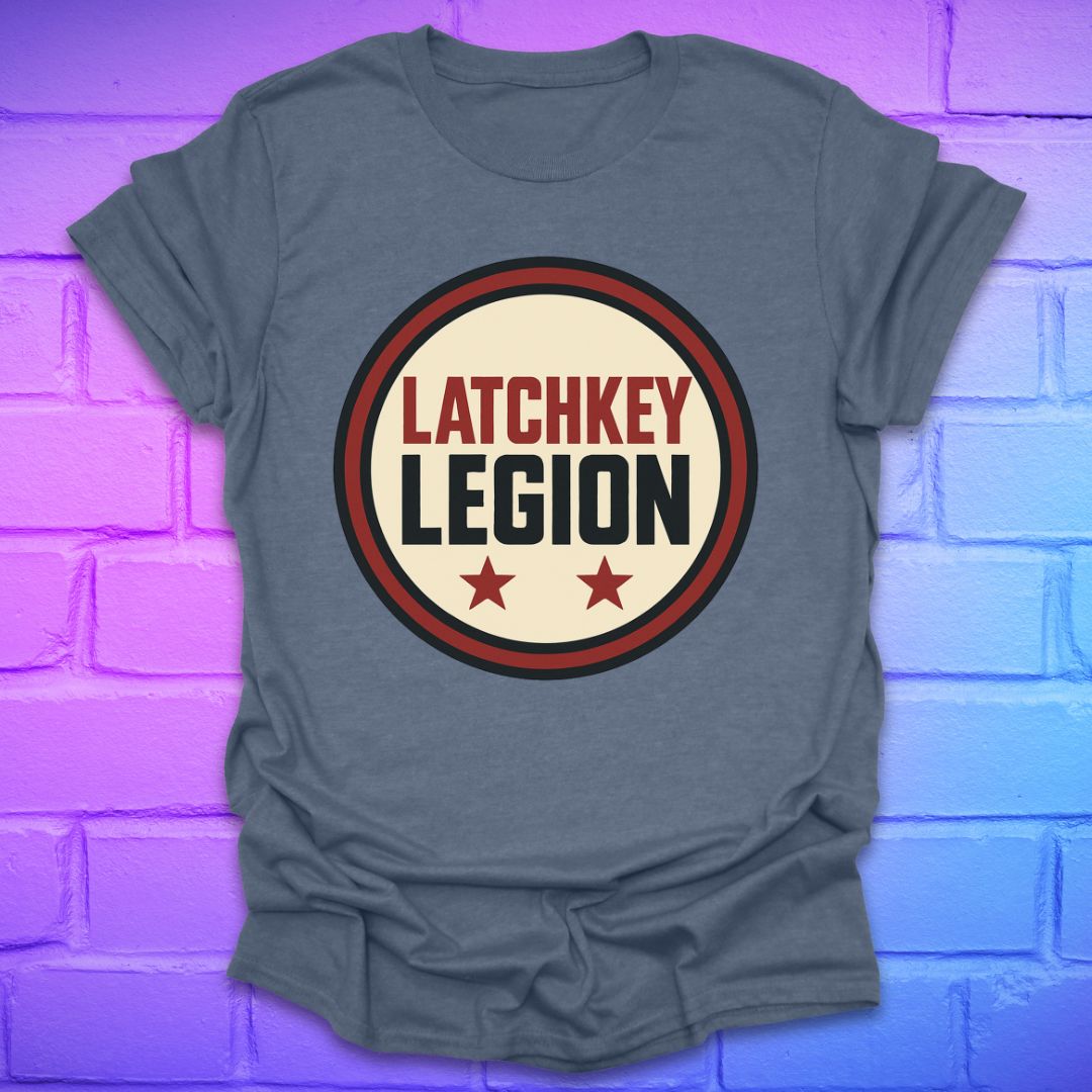 Indigo colored t-shirt with text, 'Latchkey Legion'  in a circle with stars design on a brick wall background
