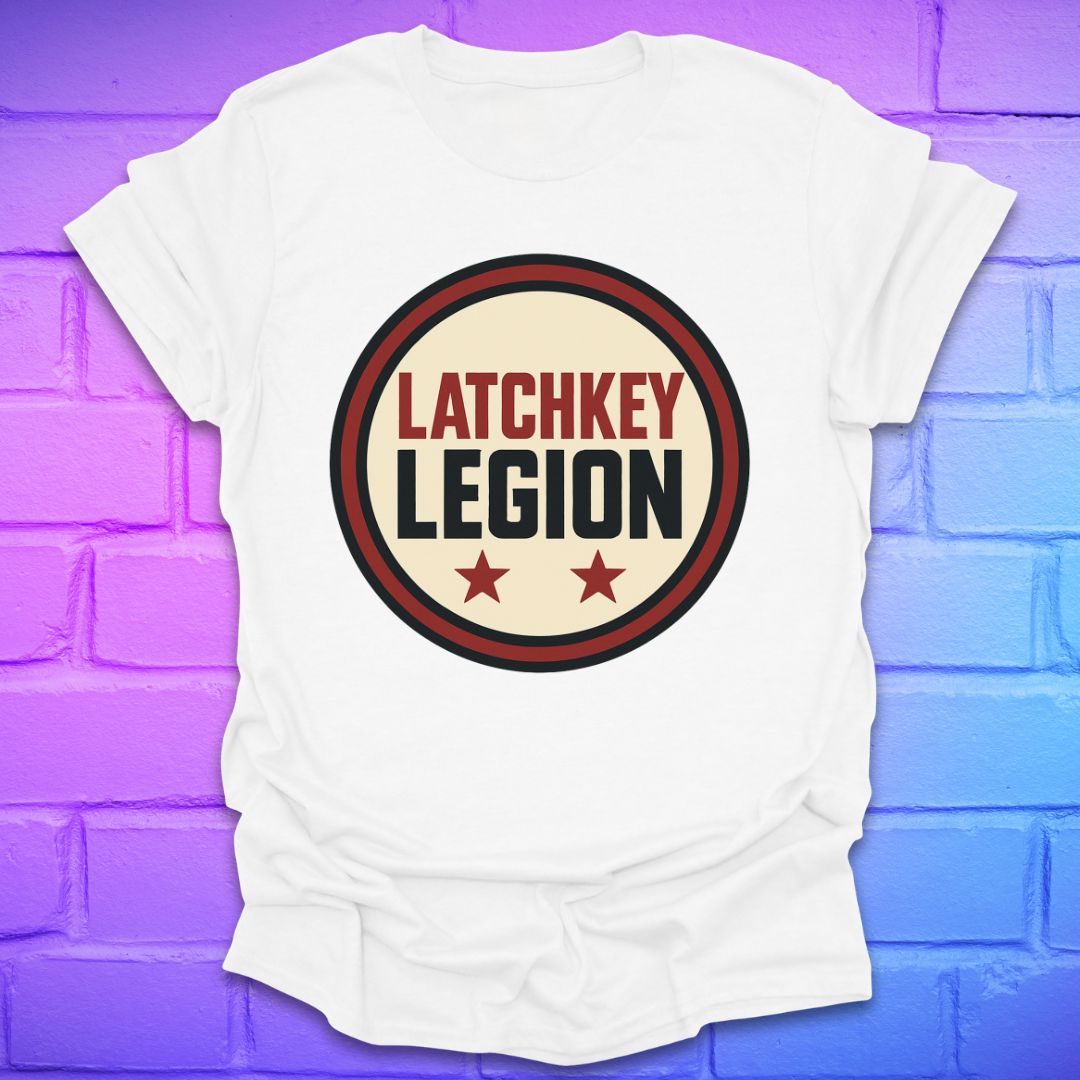 White t-shirt with text, 'Latchkey Legion'  in a circle with stars design on a brick wall background