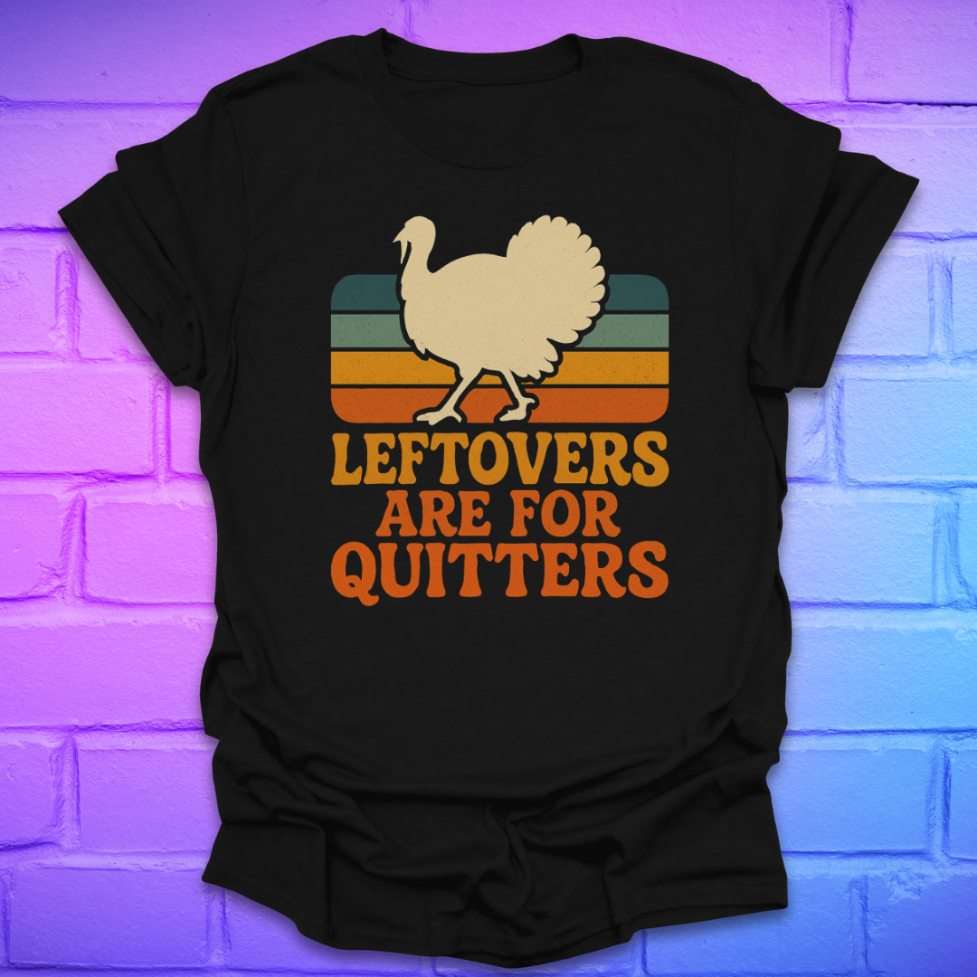 Black t-shirt with a graphic of a turkey and text 'LEFTOVERS ARE FOR QUITTERS' on a brick wall background.