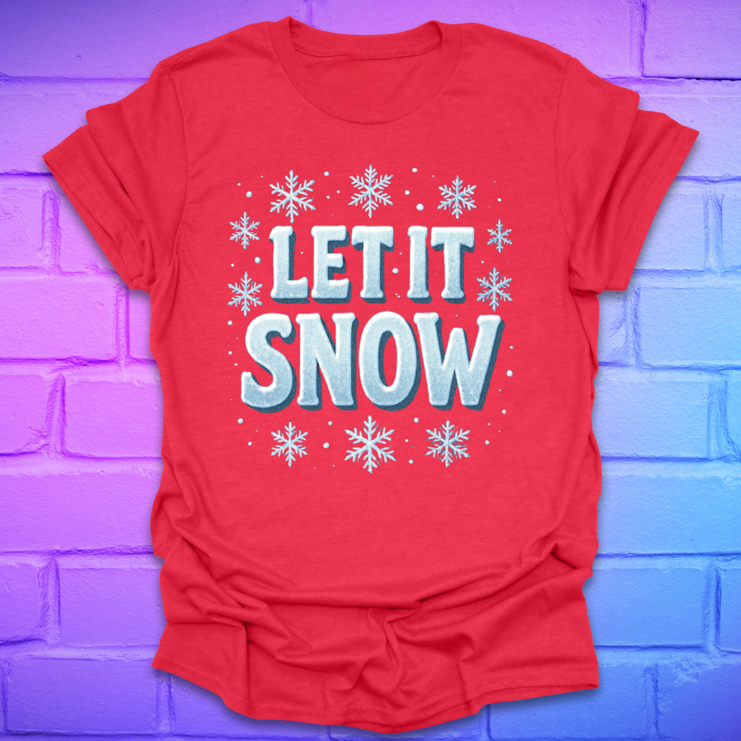 Red t-shirt with 'LET IT SNOW' text and snowflakes on a brick wall background