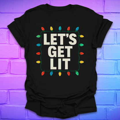 Black t-shirt with 'LET'S GET LIT' text and Christmas lights design on a brick wall background