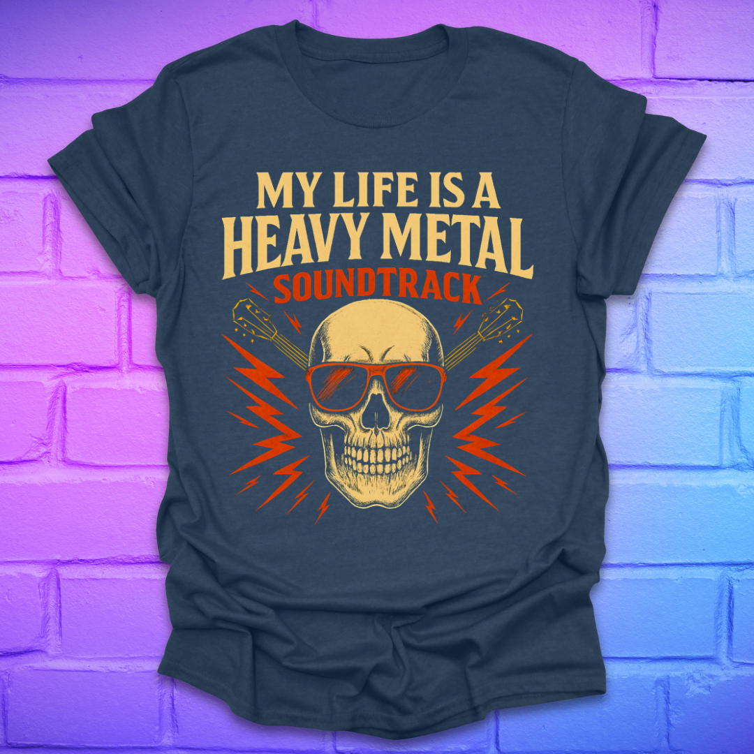 Heather navy t-shirt with a skull and guitar graphic and text, 'my life is a heavy metal soundtrack' on a brick background.