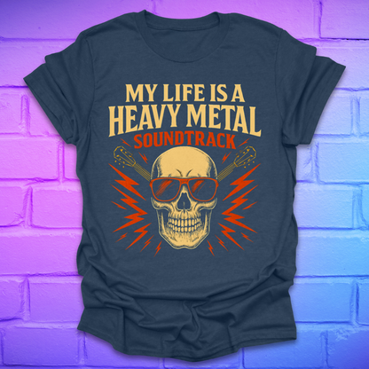 Heather navy t-shirt with a skull and guitar graphic and text, 'my life is a heavy metal soundtrack' on a brick background.