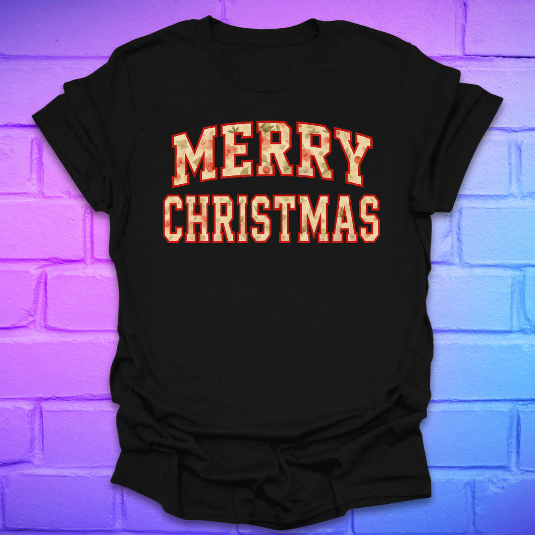 Black t-shirt with 'Merry Christmas' camo text on a brick wall background