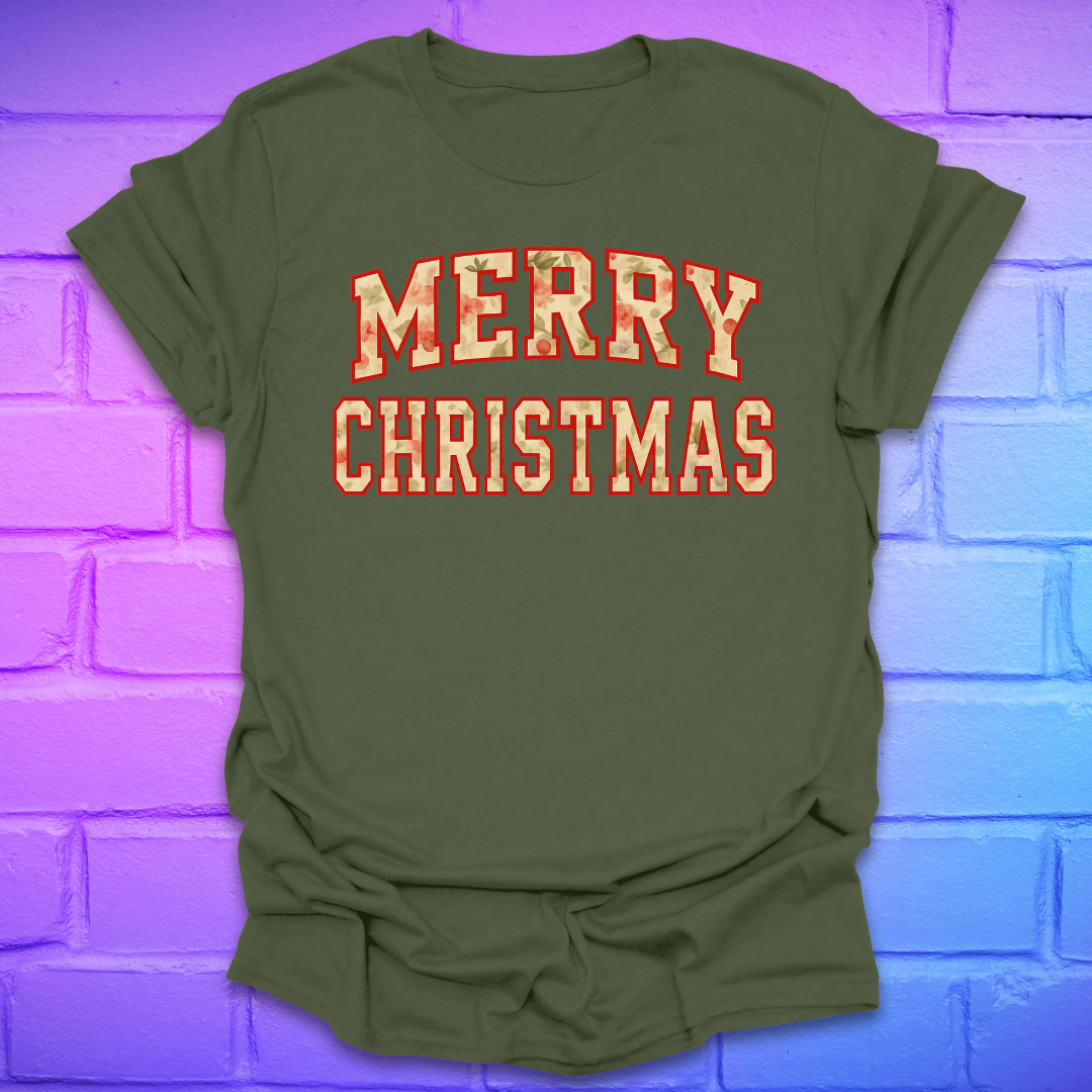 Green t-shirt with 'Merry Christmas' camo text on a brick wall background