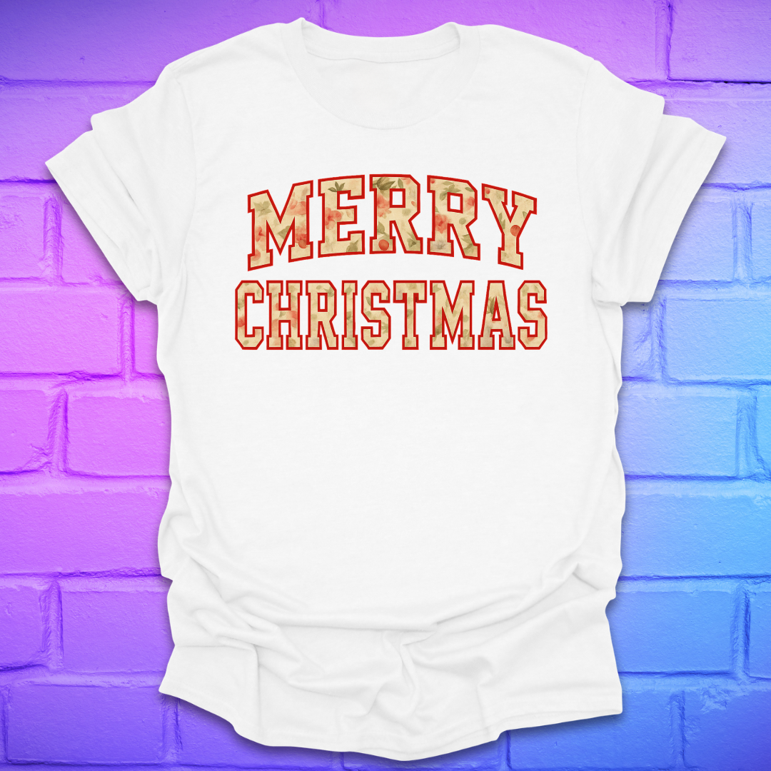 White t-shirt with 'Merry Christmas' camo text on a brick wall background