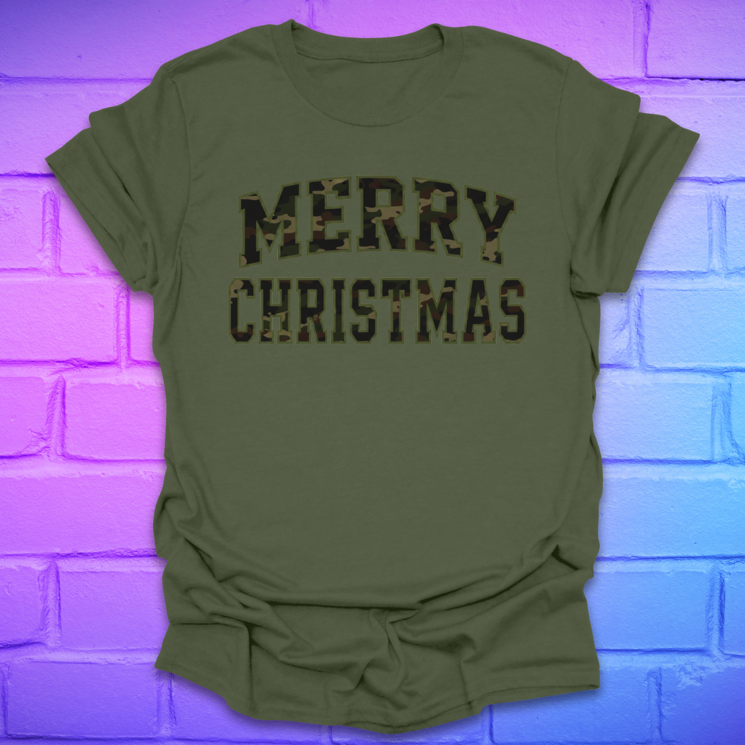 Green t-shirt with 'Merry Christmas' camo text on a brick wall background