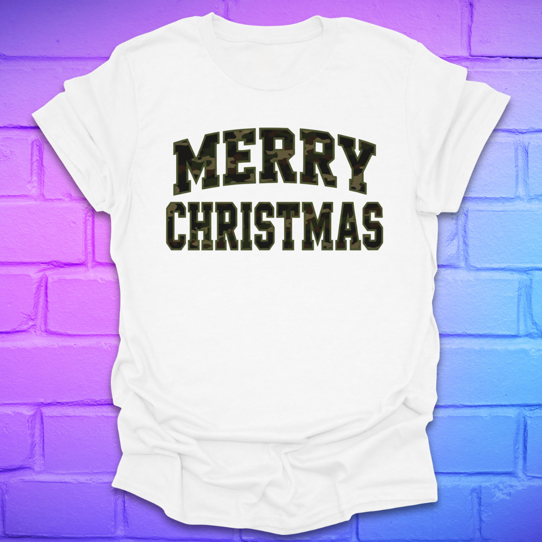 White t-shirt with 'Merry Christmas' camo text on a brick wall background