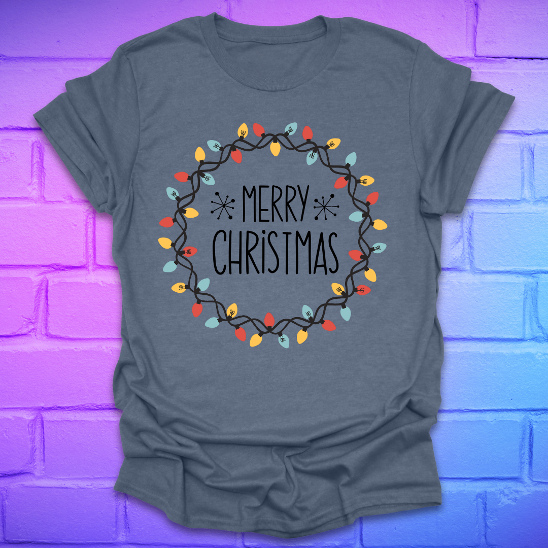 Heather indigo t-shirt with 'Merry Christmas' design with christmas lights on a brick wall background