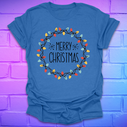 Heather royal t-shirt with 'Merry Christmas' design with christmas lights on a brick wall background
