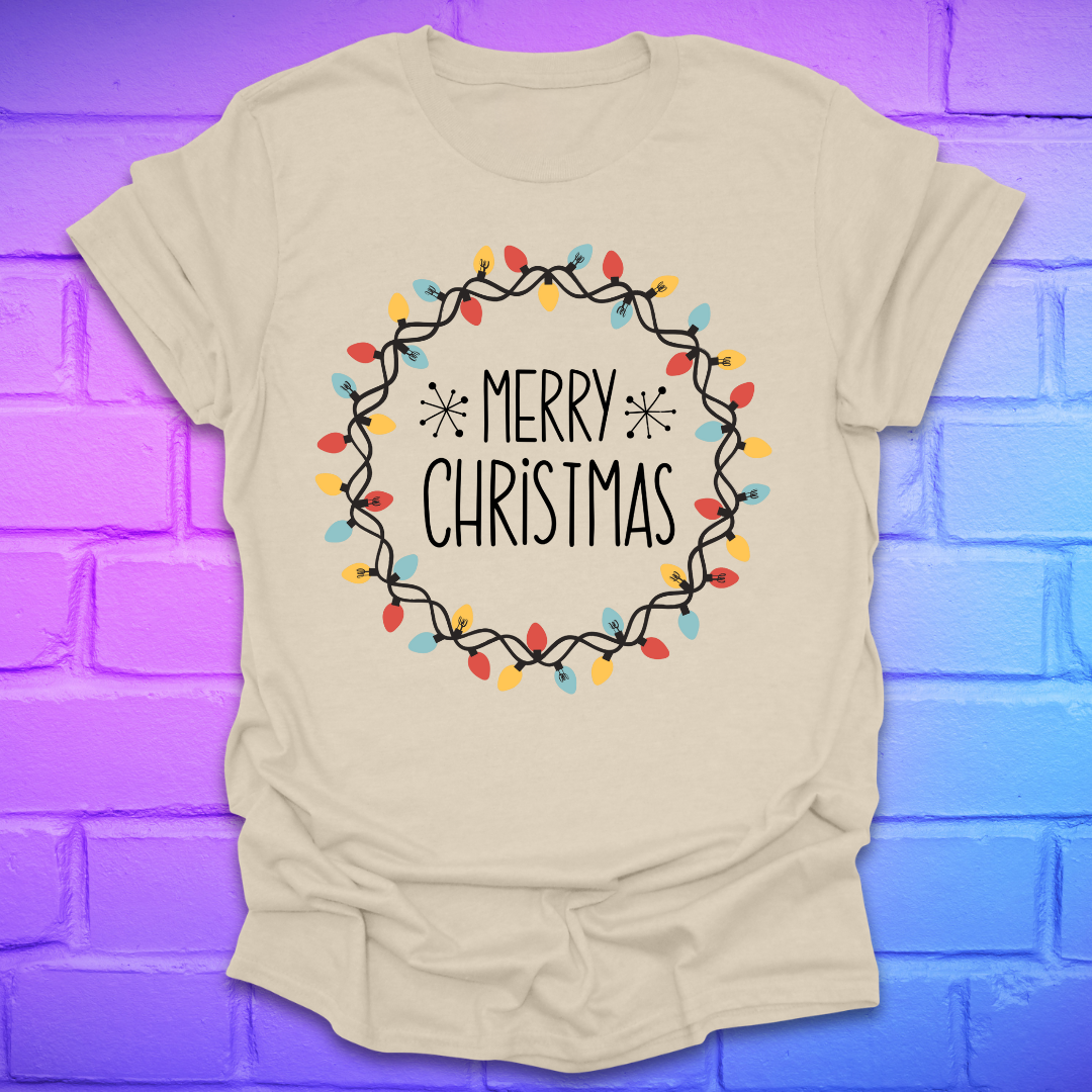 Beige t-shirt with 'Merry Christmas' design with christmas lights on a brick wall background