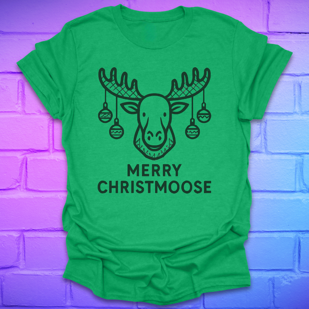 Green t-shirt with a moose graphic and 'Merry Christmoose' text on a brick wall background